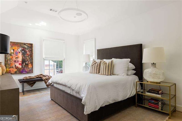 bedroom with visible vents and light wood finished floors