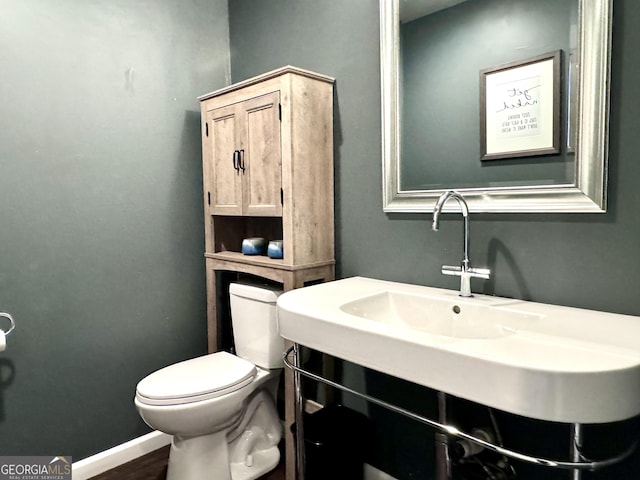half bathroom with toilet and vanity