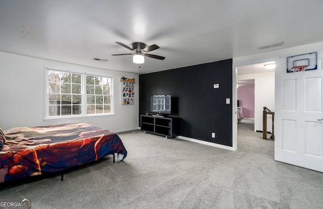 carpeted bedroom with visible vents, baseboards, and ceiling fan
