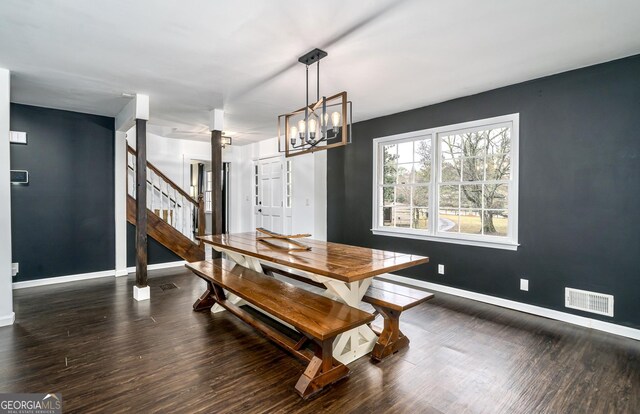 dining area with stairway, wood finished floors, visible vents, baseboards, and a chandelier