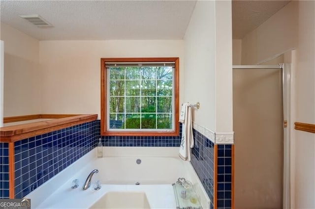 209 Red Fern Ct, Canton, GA 30114 - full bathroom with a garden tub, a shower stall, a wainscoted wall, and a textured ceiling
