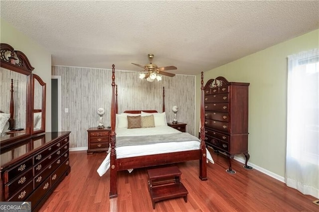 209 Red Fern Ct, Canton, GA 30114 - bedroom featuring wood finished floors, baseboards, a textured ceiling, and ceiling fan