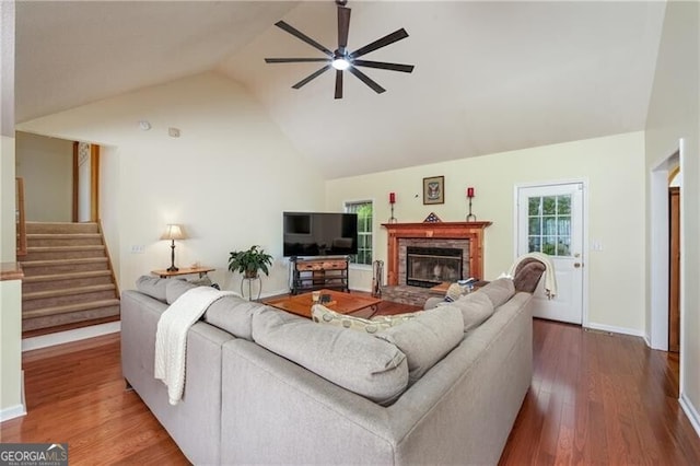 209 Red Fern Ct, Canton, GA 30114 - living room featuring ceiling fan, wood finished floors, a stone fireplace, stairway, and baseboards