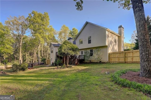209 Red Fern Ct, Canton, GA 30114 - back of house with a chimney, crawl space, and a wooden deck