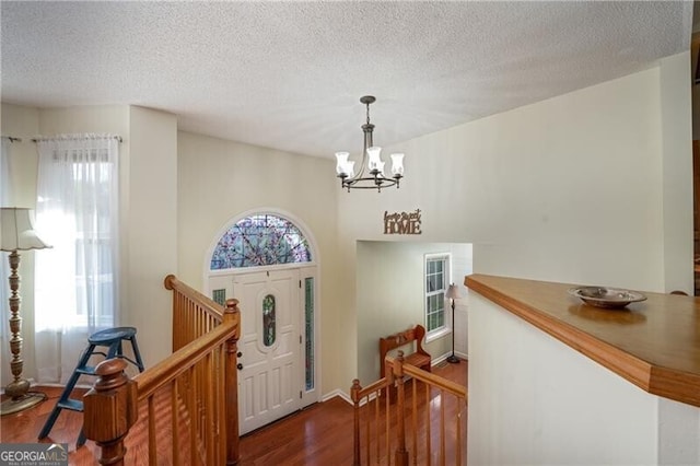 209 Red Fern Ct, Canton, GA 30114 - entryway with healthy amount of natural light, a chandelier, dark wood finished floors, and a textured ceiling