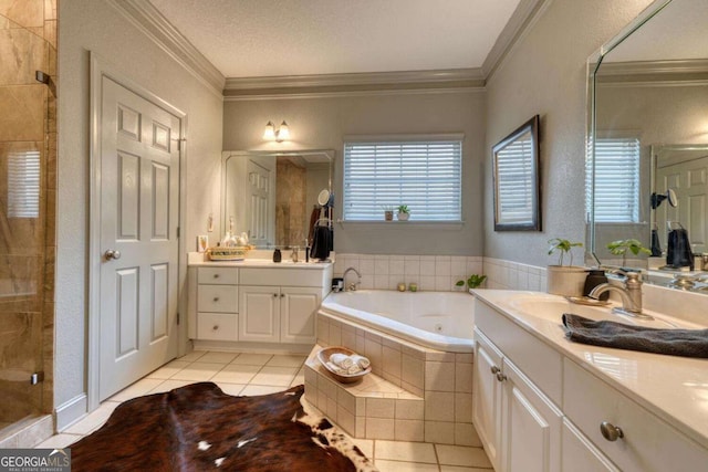 bathroom with a shower stall, tile patterned floors, a tub with jets, two vanities, and crown molding