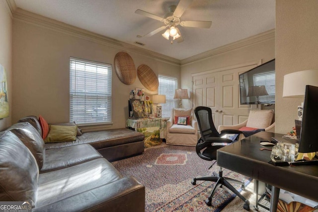 carpeted office with a ceiling fan and ornamental molding