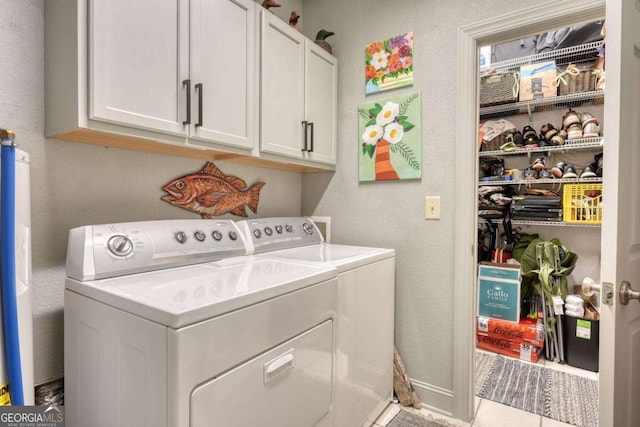 washroom featuring washing machine and dryer and cabinet space