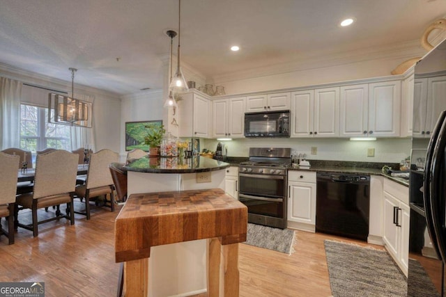 kitchen with black appliances, dark countertops, white cabinetry, ornamental molding, and light wood finished floors