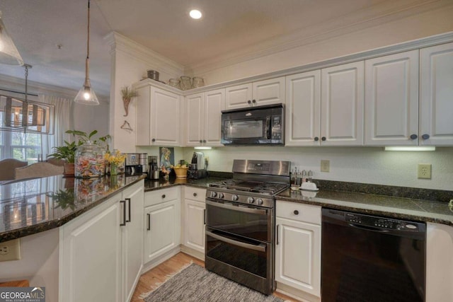 kitchen with black appliances, ornamental molding, light wood-type flooring, white cabinetry, and hanging light fixtures