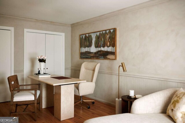 office area with crown molding, wood finished floors, and wainscoting