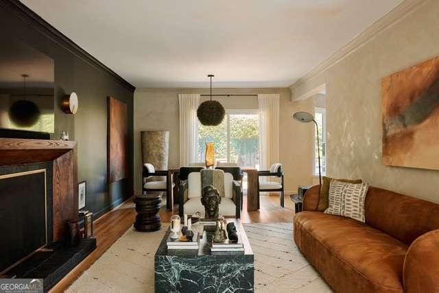 living room featuring crown molding and wood finished floors