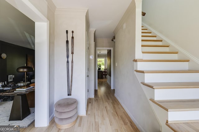 interior space with ornamental molding, baseboards, stairway, and wood finished floors