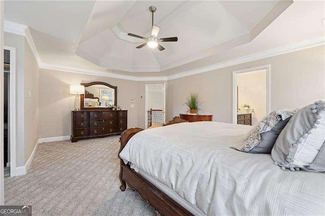 310 Kingspring Ct, Roswell, GA 30076 - carpeted bedroom featuring crown molding, ceiling fan, ensuite bath, a raised ceiling, and baseboards