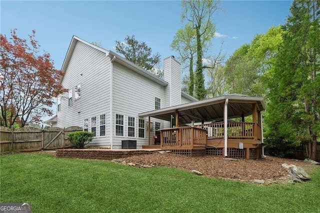 310 Kingspring Ct, Roswell, GA 30076 - rear view of house featuring a wooden deck, central AC, a lawn, fence, and a chimney