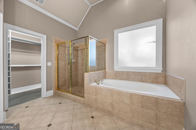 774 Mary Ann Dr NE, Marietta, GA 30068 - bathroom featuring ornamental molding, vaulted ceiling, a stall shower, tile patterned flooring, and a garden tub