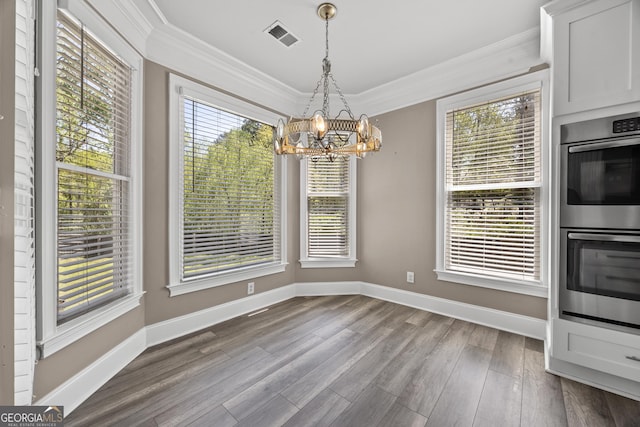774 Mary Ann Dr NE, Marietta, GA 30068 - unfurnished dining area with a notable chandelier, baseboards, crown molding, dark wood-type flooring, and visible vents