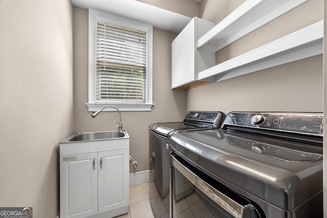 774 Mary Ann Dr NE, Marietta, GA 30068 - laundry room with baseboards, separate washer and dryer, a sink, cabinet space, and light tile patterned flooring