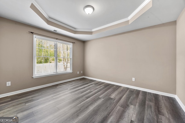 774 Mary Ann Dr NE, Marietta, GA 30068 - unfurnished room with visible vents, baseboards, a raised ceiling, ornamental molding, and dark wood finished floors