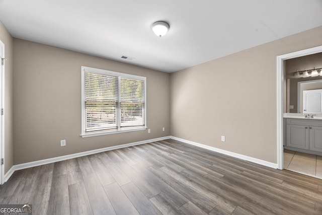 774 Mary Ann Dr NE, Marietta, GA 30068 - spare room with baseboards, wood finished floors, a sink, and visible vents