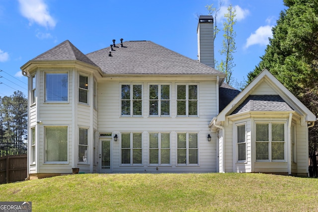 774 Mary Ann Dr NE, Marietta, GA 30068 - back of property with fence, a shingled roof, a lawn, and a chimney