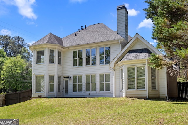 774 Mary Ann Dr NE, Marietta, GA 30068 - back of house with a chimney, a shingled roof, fence, and a lawn