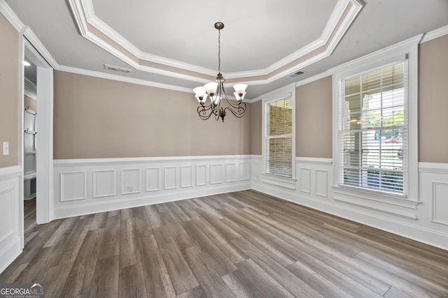 774 Mary Ann Dr NE, Marietta, GA 30068 - unfurnished dining area featuring a tray ceiling, wood finished floors, a notable chandelier, and visible vents