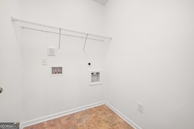 laundry room featuring electric dryer hookup, baseboards, washer hookup, and stone finish flooring
