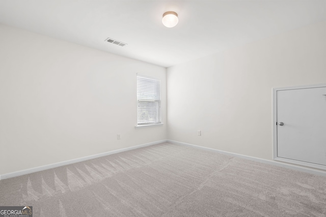 carpeted empty room with baseboards