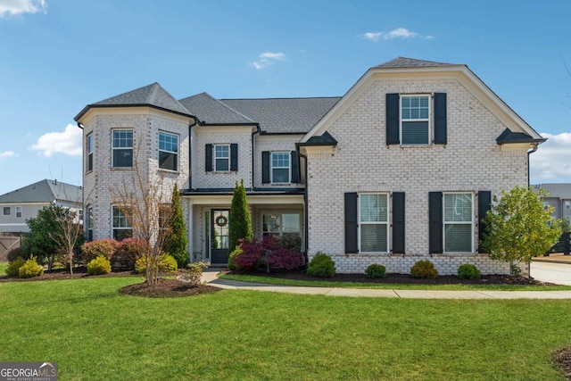 214 Leland Way, Woodstock, GA 30188 - view of front of house with brick siding, a front lawn, and a shingled roof
