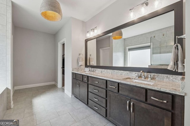 214 Leland Way, Woodstock, GA 30188 - full bath featuring tile patterned floors, double vanity, baseboards, and a sink