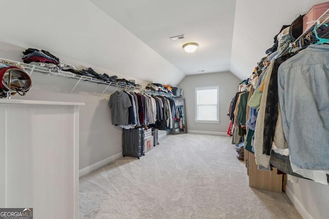 214 Leland Way, Woodstock, GA 30188 - walk in closet featuring visible vents, light colored carpet, and lofted ceiling
