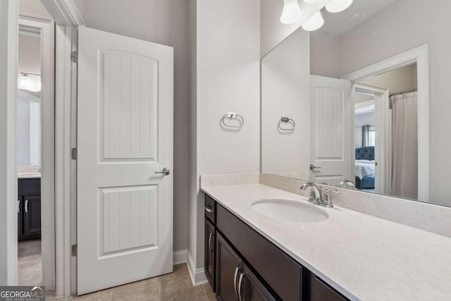 214 Leland Way, Woodstock, GA 30188 - ensuite bathroom featuring tile patterned flooring, baseboards, connected bathroom, and vanity