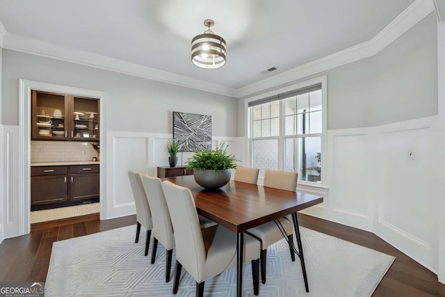 214 Leland Way, Woodstock, GA 30188 - dining space with dark wood-type flooring, ornamental molding, and a wainscoted wall