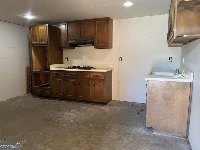 745 Pleasant Valley Rd SE, Silver Creek, GA 30173 - kitchen featuring ventilation hood, concrete floors, light countertops, a sink, and gas stovetop