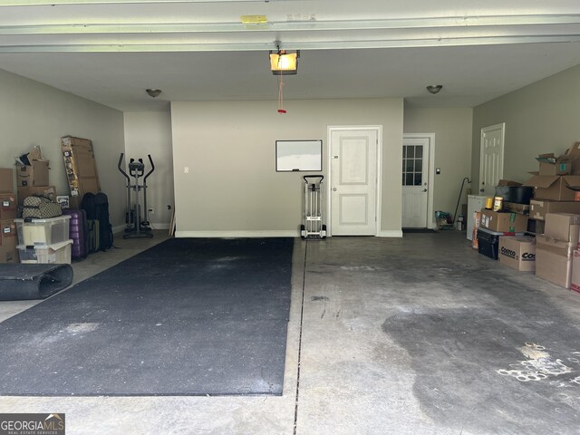 745 Pleasant Valley Rd SE, Silver Creek, GA 30173 - garage with a garage door opener and baseboards