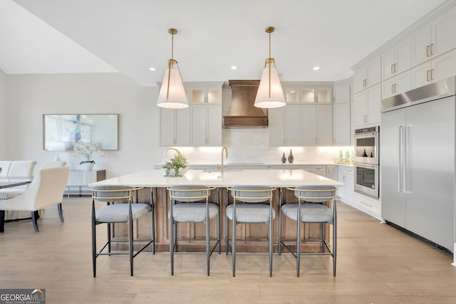 123 Candler Loop, Acworth, GA 30101 - kitchen with appliances with stainless steel finishes, wall chimney exhaust hood, light countertops, white cabinets, and glass insert cabinets