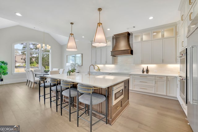 123 Candler Loop, Acworth, GA 30101 - kitchen with custom range hood, stainless steel appliances, light wood-style floors, light countertops, and lofted ceiling