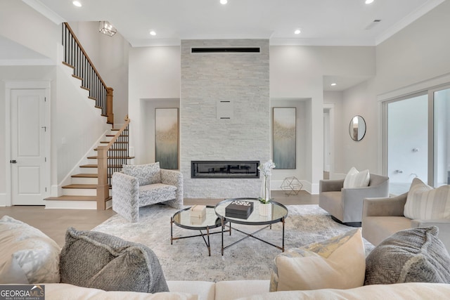 123 Candler Loop, Acworth, GA 30101 - living room featuring a fireplace, stairs, ornamental molding, and recessed lighting