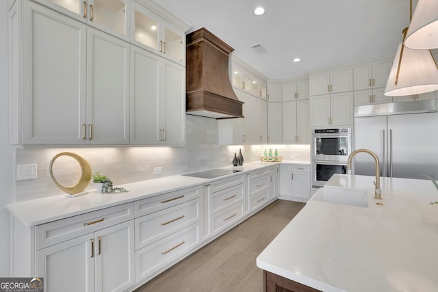 123 Candler Loop, Acworth, GA 30101 - kitchen featuring custom exhaust hood, stainless steel appliances, white cabinets, tasteful backsplash, and glass insert cabinets