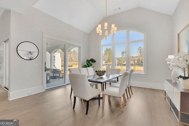123 Candler Loop, Acworth, GA 30101 - dining space featuring light wood-style flooring, a chandelier, and vaulted ceiling