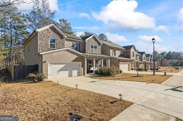75 Glen Abbey Cir, Fairburn, GA 30213 - view of front of home with an attached garage, concrete driveway, fence, and stone siding