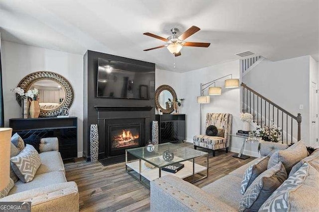 75 Glen Abbey Cir, Fairburn, GA 30213 - living room with baseboards, a fireplace, stairs, ceiling fan, and wood finished floors