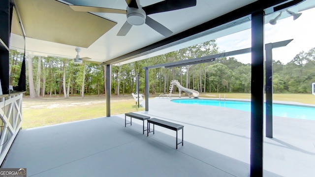 view of patio with ceiling fan and an outdoor pool