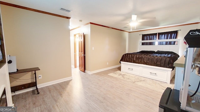 bedroom featuring ornamental molding, light wood-style floors, baseboards, and ceiling fan