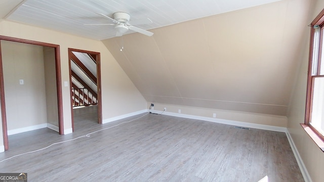 bonus room featuring a ceiling fan, vaulted ceiling, wood finished floors, and baseboards