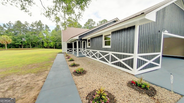 view of side of property with a yard