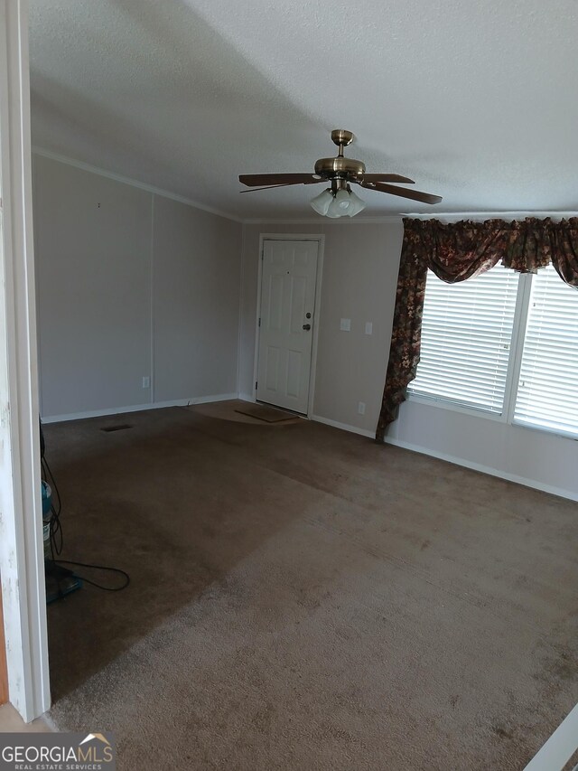 2791 Pulaski Rd, Statesboro, GA 30458 - carpeted foyer entrance with baseboards, a textured ceiling, ornamental molding, and ceiling fan