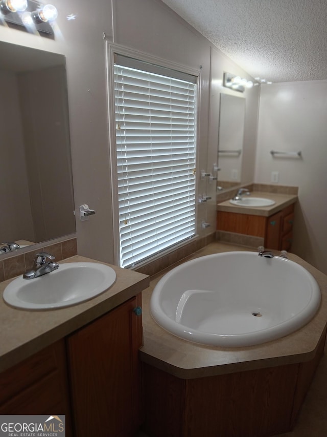2791 Pulaski Rd, Statesboro, GA 30458 - full bath featuring a textured ceiling, two vanities, a sink, and a bath