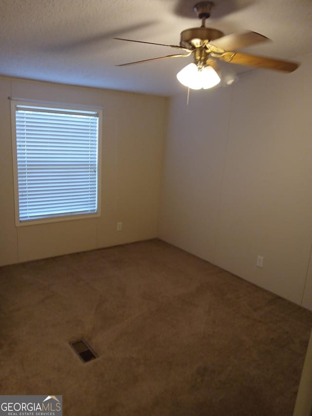 2791 Pulaski Rd, Statesboro, GA 30458 - spare room featuring carpet, a ceiling fan, and visible vents